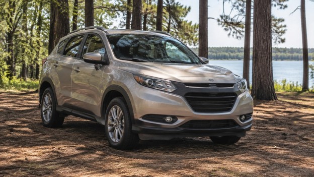 Photo for used car air conditioning in Conroe TX: tan crossover parked in the shade of tall pine trees