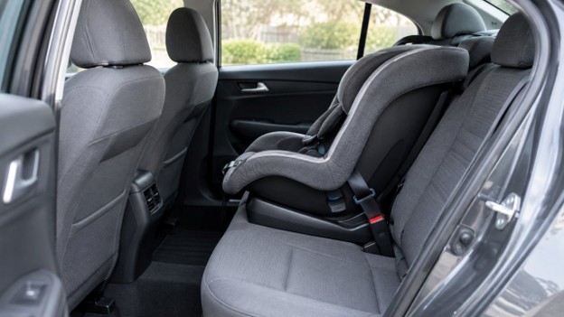 Gville 10.7.26 Illustration for used car safety ratings in Gainesville FL: child car seat installed in a clean back seat