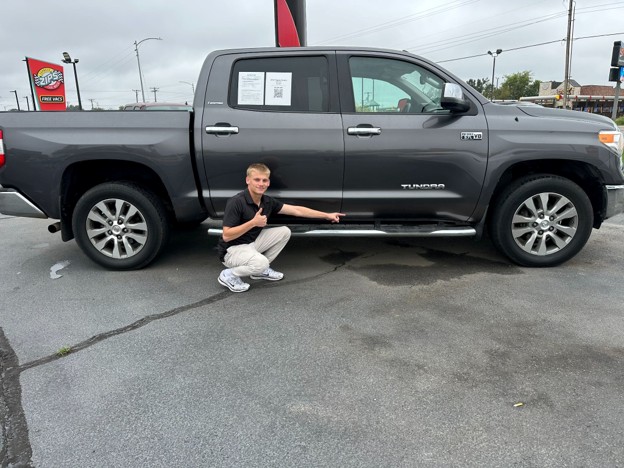 Buyer inspecting a used truck bed while shopping for used trucks Joplin MO