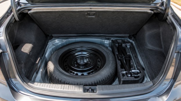 Midtown 10.14 Photo for used car spare tire in San Antonio TX: trunk with a spare tire, jack and too
